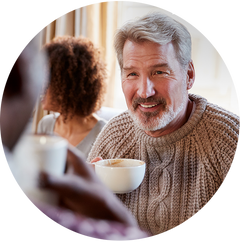 man holding cup of coffee